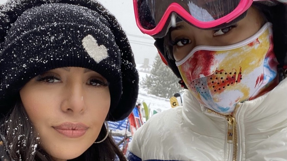 Vanessa Bryant, in winter hat, in snow, taking selfie; Natalia Bryant in ski gear, face mask