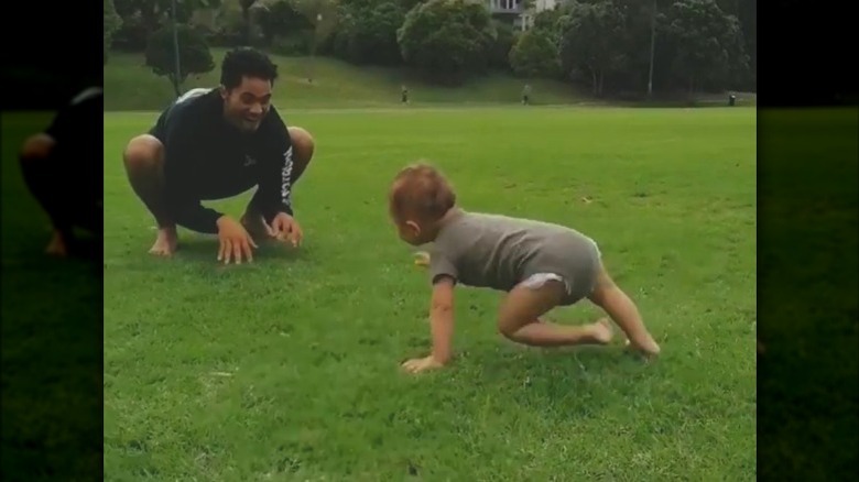 Alex Tarrant playing with son