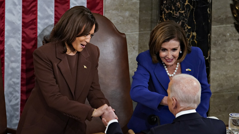 Kamala Harris and Nancy Pelosi shake Joe Biden's hand