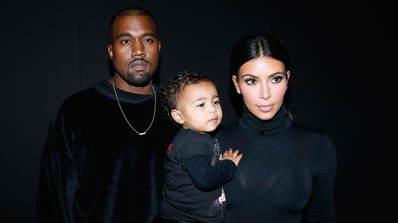 Kanye, Kim, and North West wearing black