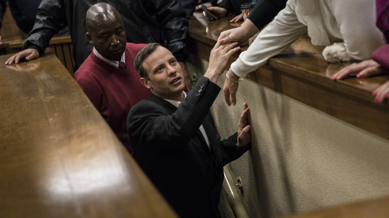 Oscar Pistorius exiting a courtroom