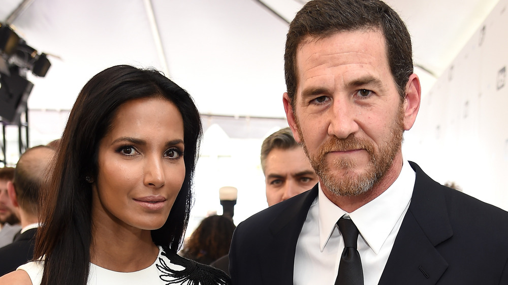 Padma Lakshmi and Adam Dell posing on the red carpet 