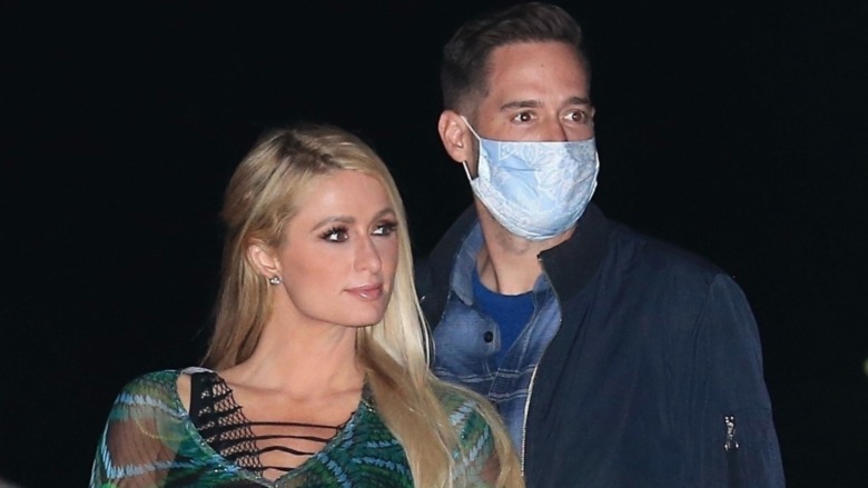 Paris Hilton posing with a masked Carter Reum