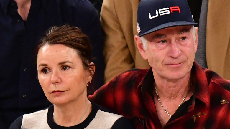 Patty Smyth and John McEnroe sitting courtside