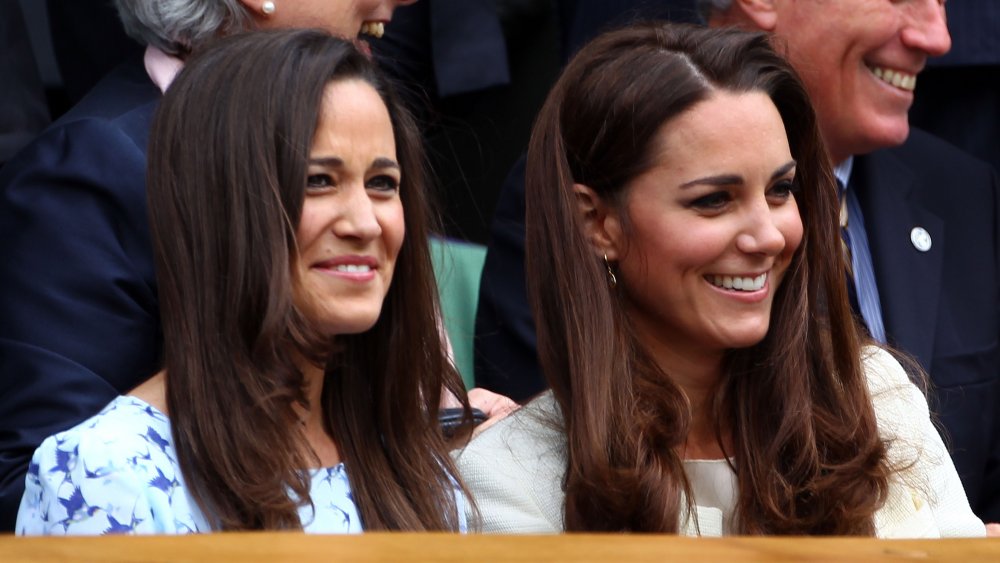 Pippa Middleton and Kate Middleton smiling and chatting