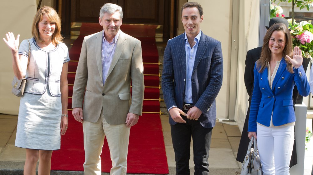 Carole Middleton, Michael Middleton, James Middleton, and Pippa Middleton standing in a line and smiling