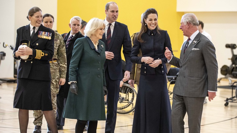 Camilla, Duchess of Cornwall, Prince William, Duke of Cambridge, Catherine, Duchess of Cambridge and Prince Charles, Prince of Wales laughing during a joint visit to the defence medical rehabilitation centre