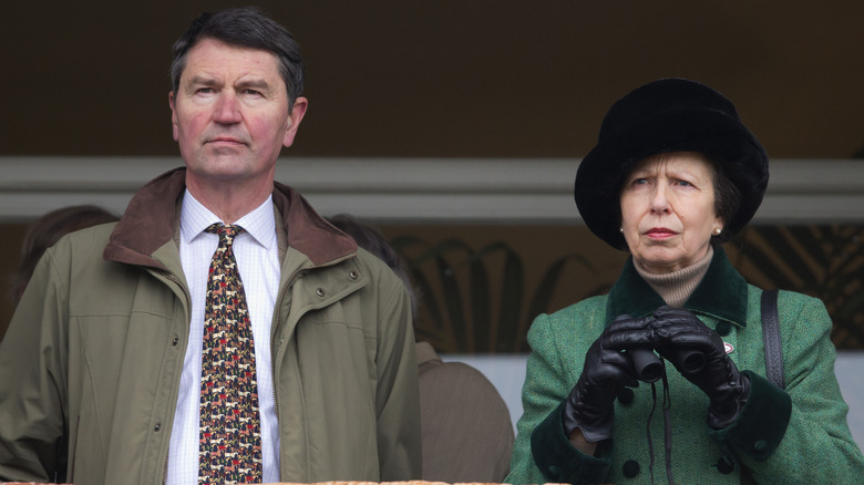 Princess Anne and Sir Timothy Laurence looking stern