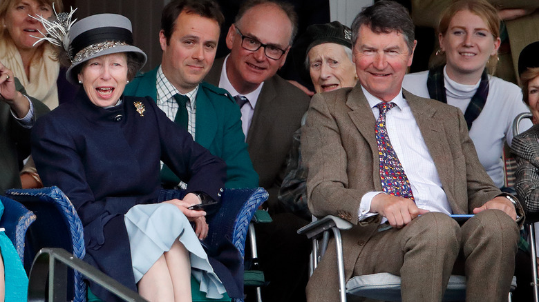 Princess Anne and Sir Timothy Laurence talking in a crowd