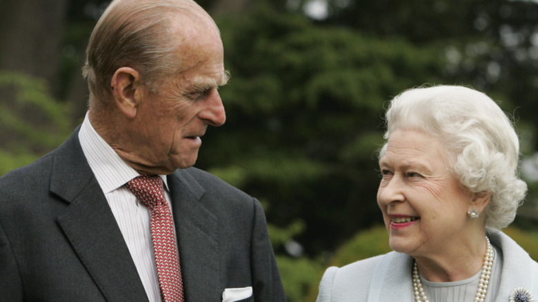 Prince Philip and Queen Elizabeth smiling at each other