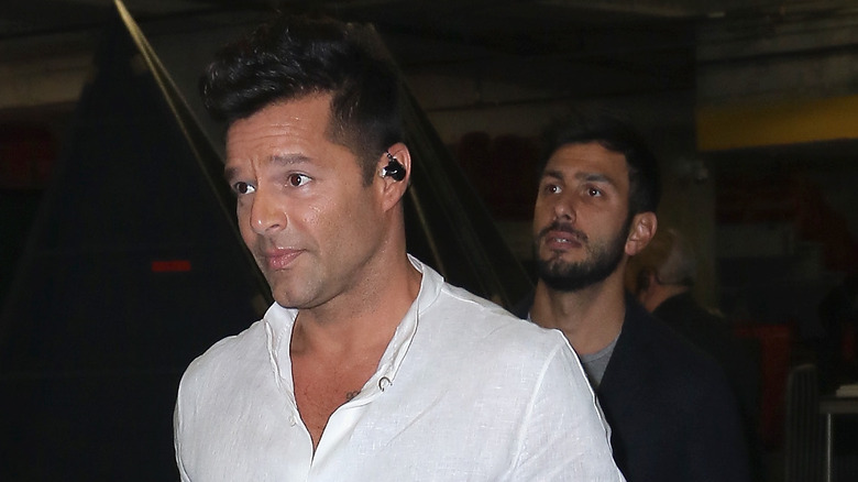 Ricky Martin walking ahead of Jwan Yosef