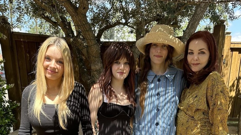 Finley Lockwood, Harper Lockwood, Riley Keough, Priscilla Presley standing in shade