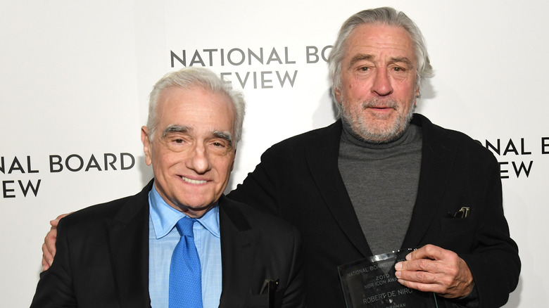 Rober De Niro and Martin Scorsese posing together, both smiling