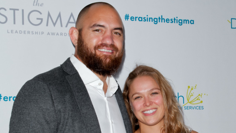 Travis Browne and Ronda Rousey smiling at an event