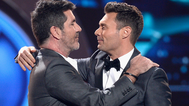 Ryan Seacrest and Simon Cowell embrace