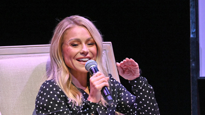 Kelly Ripa holding micropohone, speaking