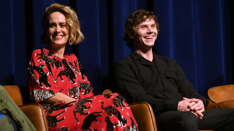 Sarah Paulson and Evan Peters onstage smiling