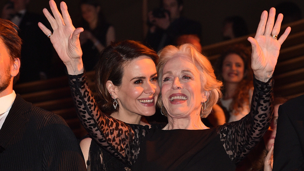 Sarah Paulson laughing and Holland Taylor with arms raised