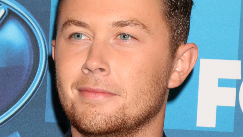 Scotty McCreery looking thoughtful at an event