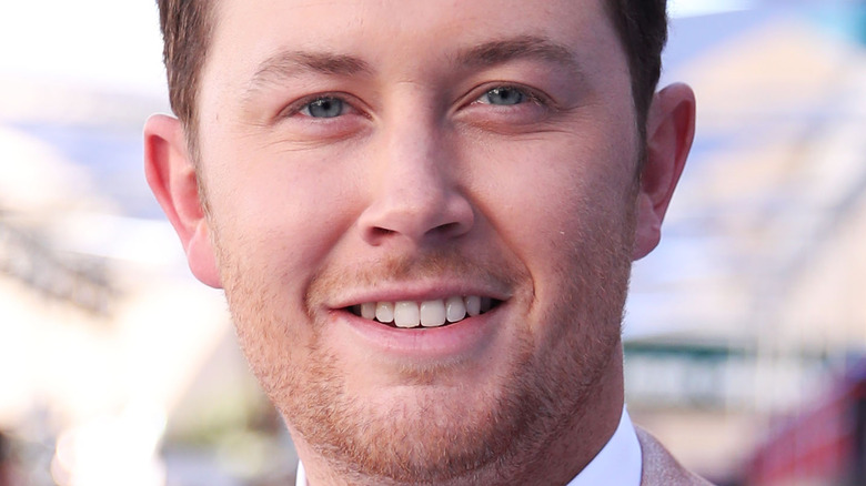 Scotty McCreery grinning at an event