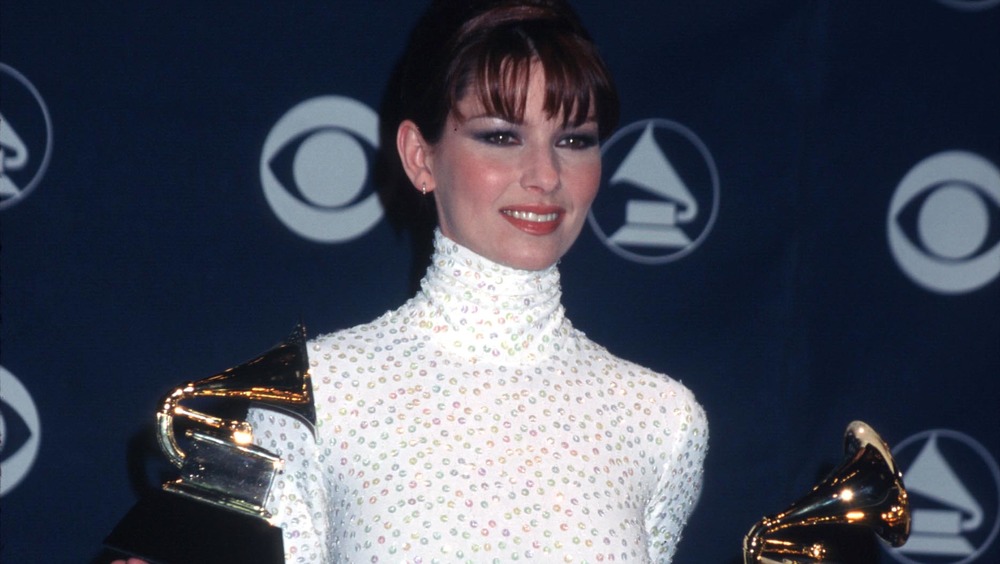 Shania Twain holding two Grammy Awards