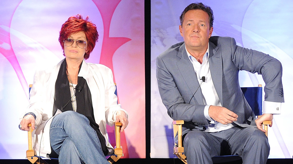 Sharon Osbourne sitting alongside Piers Morgan at an event