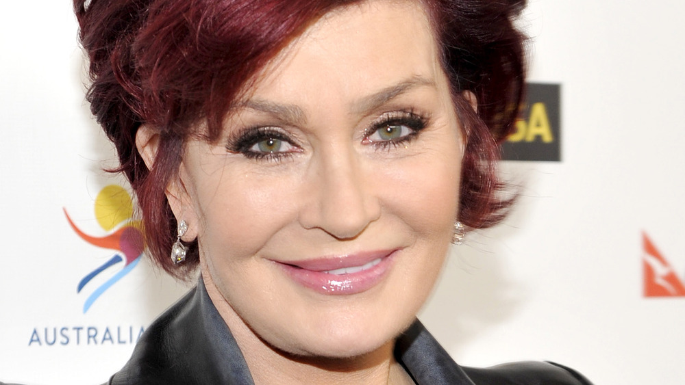 Sharon Osbourne gives a light smile