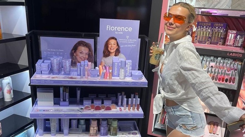 Millie Bobby Brown posing with beauty products