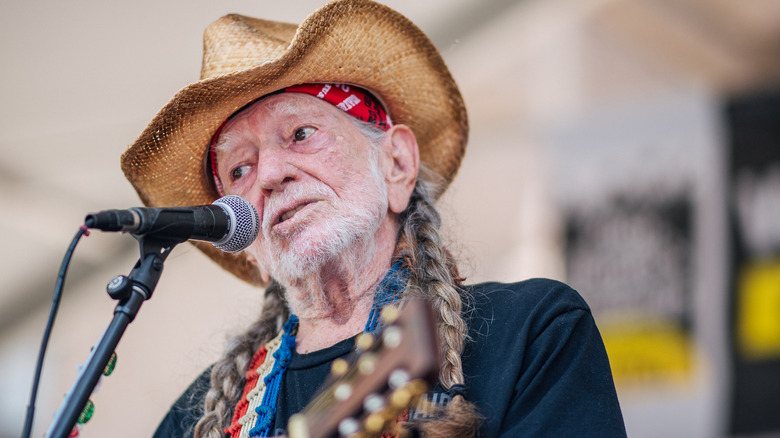 Willie Nelson braided hair straw hat singing