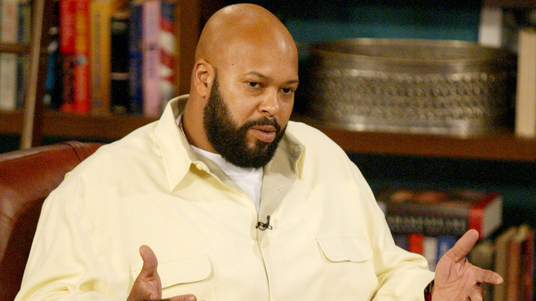 Suge Knight talking in a yellow shirt