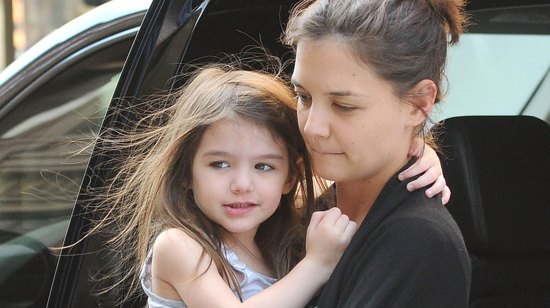 Suri Cruise and Katie Holmes getting out of a car