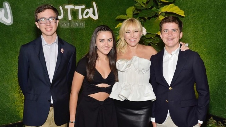 Sutton Stracke and her kids smiling at an event