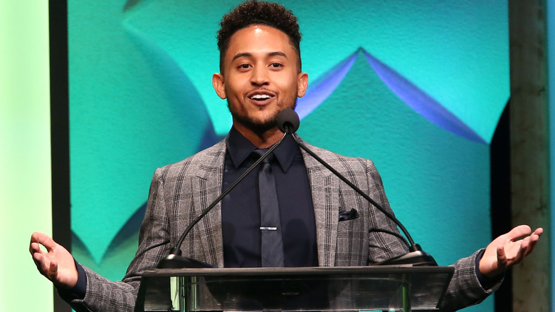 Tahj Mowry speaking to crowd at podium