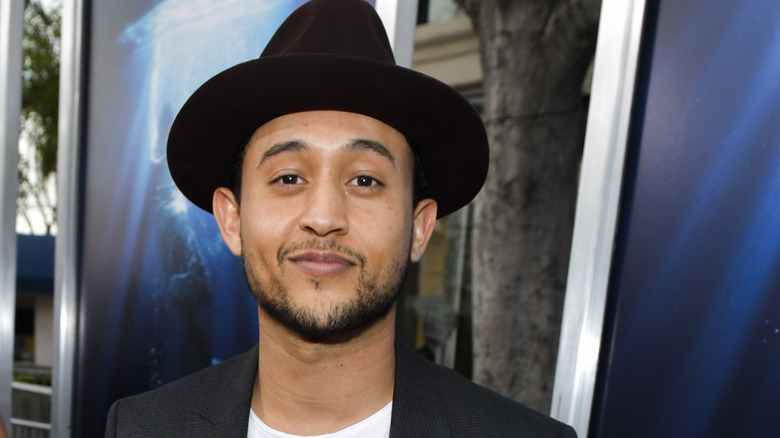 Tahj Mowry looks at camera