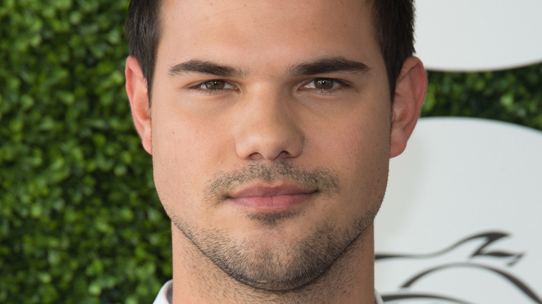 Taylor Lautner posing in suit