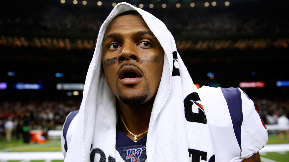 Deshaun Watson with his mouth open and towel on his head after a game