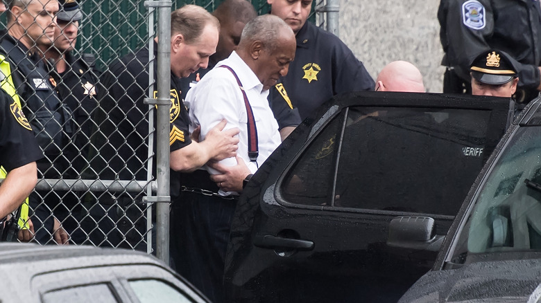 Bill Cosby being escorted from court