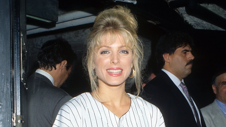 Marla Maples smiles with poofy hair