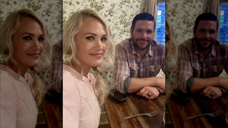 Carrie Underwood and Mike Fisher at a table