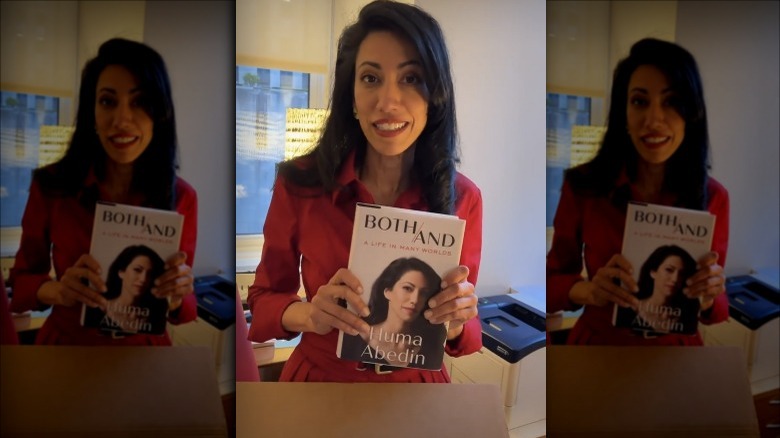 Huma Abedin displaying her book