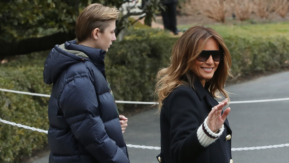 Barron Trump and Melania Trump walking outside