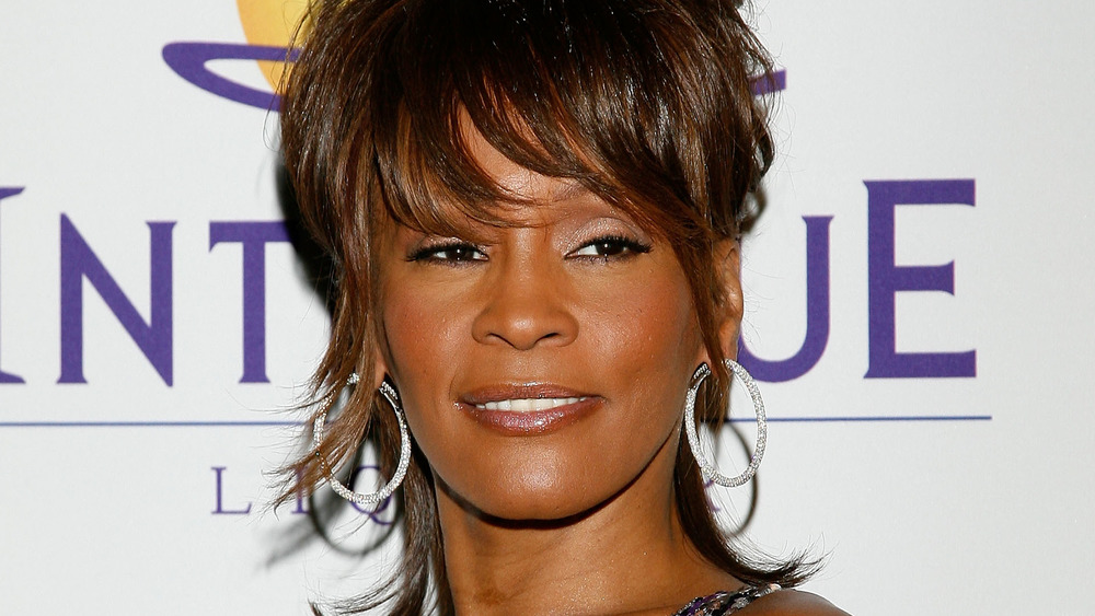 Whitney Houston smirking