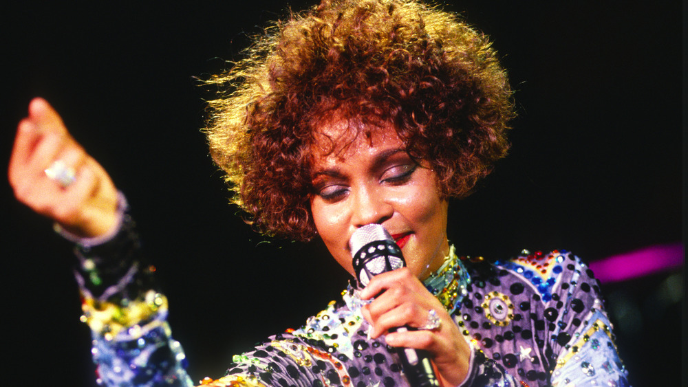 Whitney Houston holding a microphone