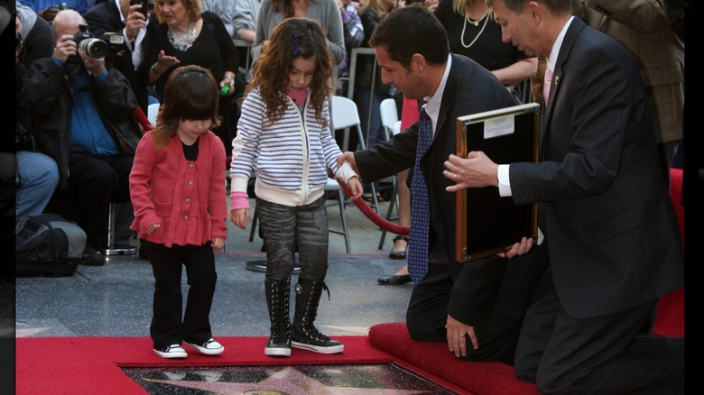 Adam Sandler showing his daughters his Hollywood star