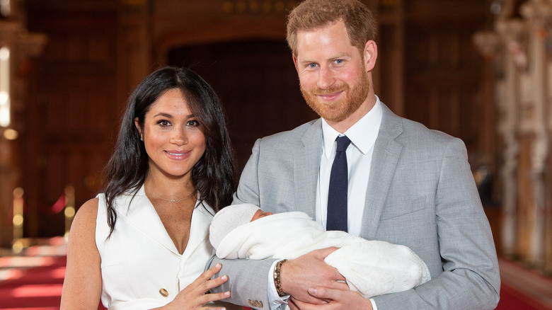 Meghan Markle and Prince Harry holding son Archie