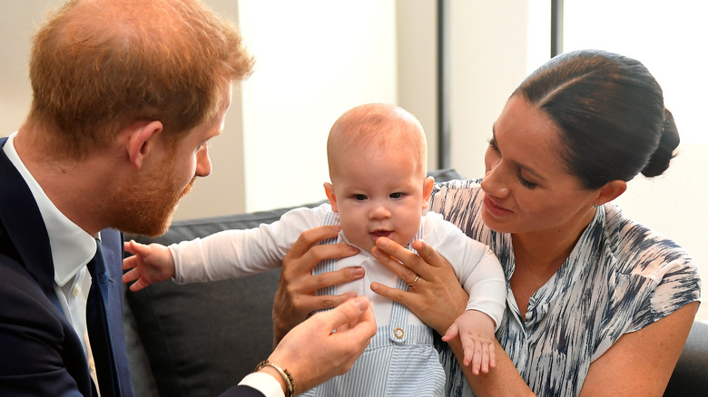 Prince Harry and Meghan Markle holding son Archie