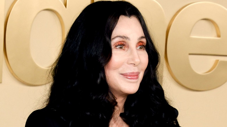 Cher in black and white hat