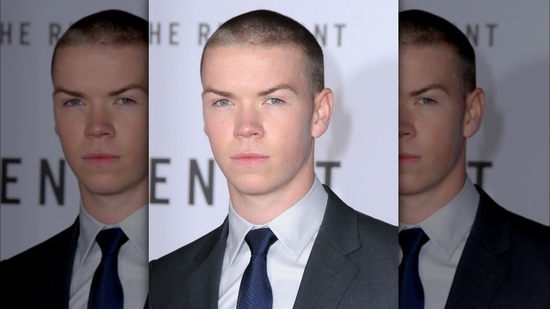 Will Poulter shaved head looking serious