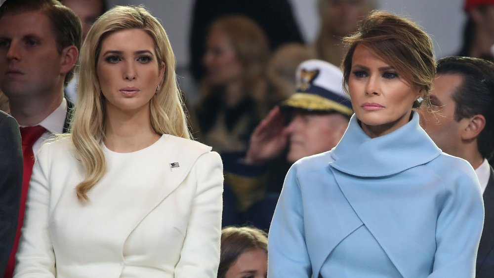 First lady Melania Trump (R), stands with Ivanka Trump as a parade passes the inaugural parade reviewing stand in front of the White House on January 20, 2017