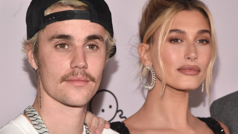 Hailey Bieber and Justin Bieber and Hailey Baldwin looking stonefaced at a red carpet event 